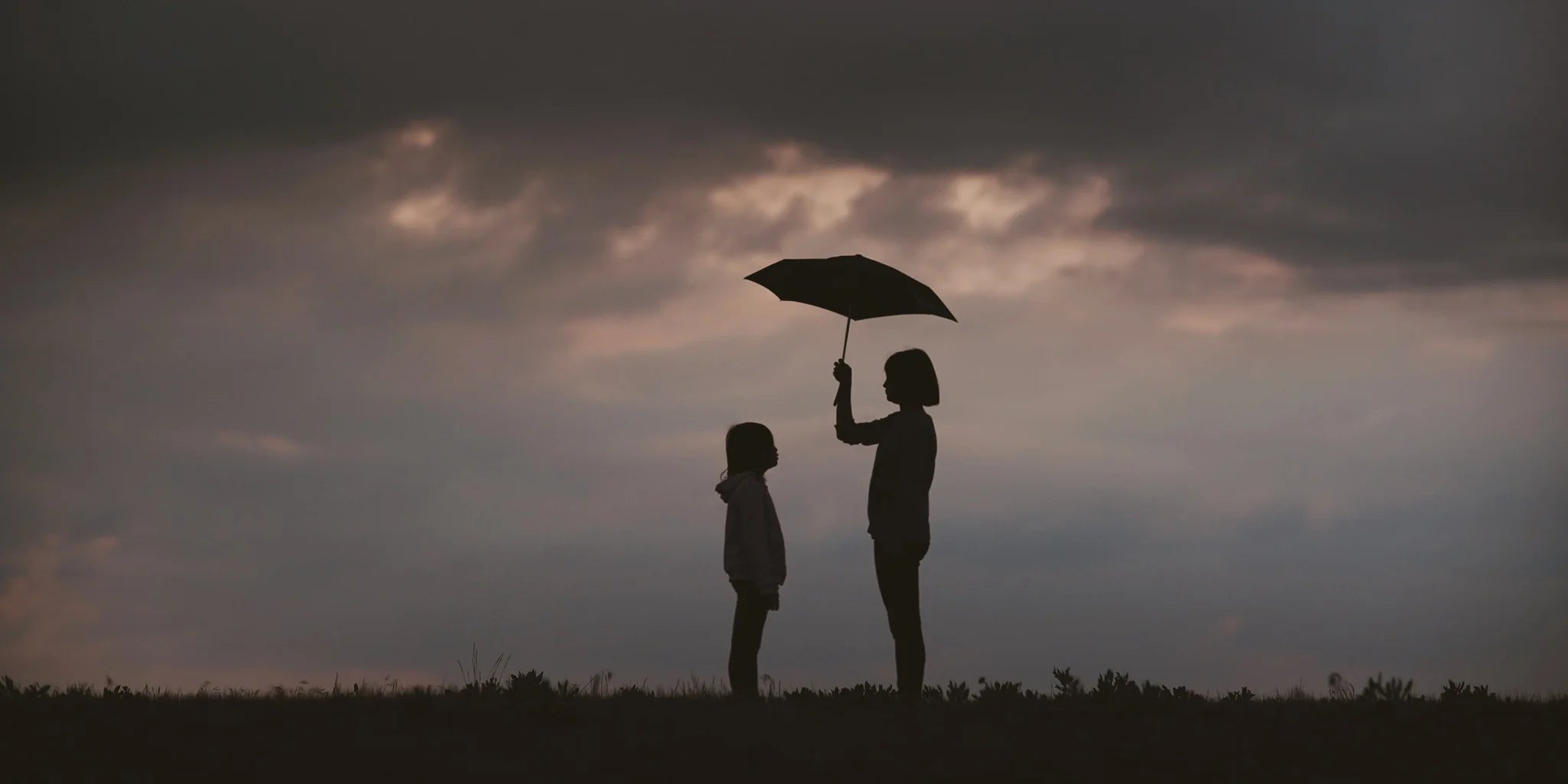 2 children standing under an umbrella on a cloudy day | WALL ART by Sonia