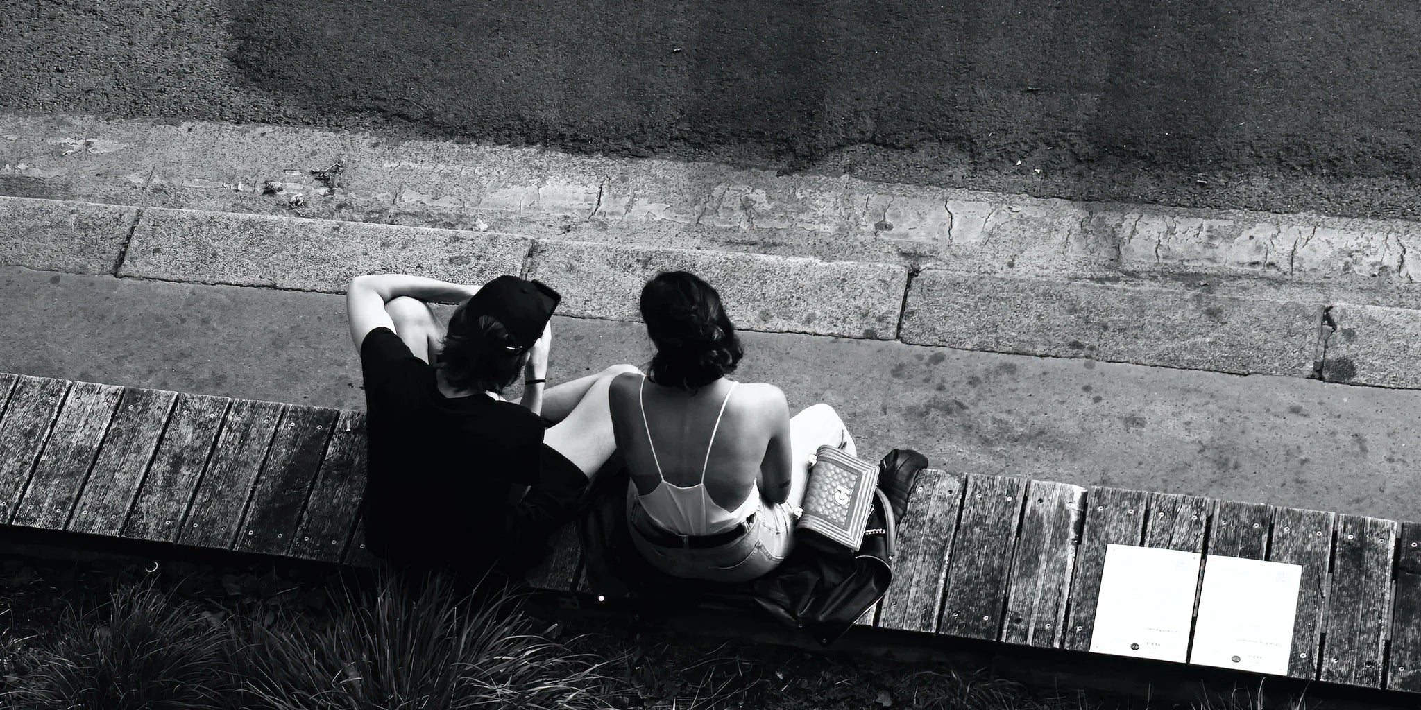 Couple sitting on stone wall talking | WALL ART by Sonia