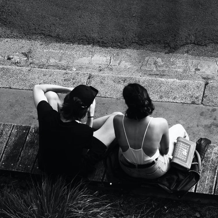 Couple sitting on stone wall talking | WALL ART by Sonia